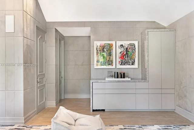 a room with furniture and a open kitchen view