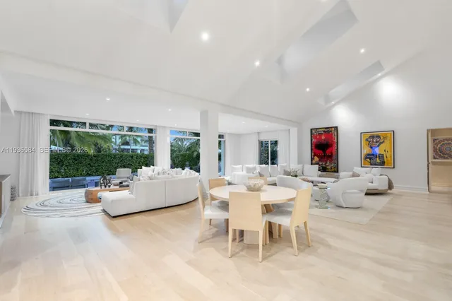 a living room with fireplace furniture and a large window