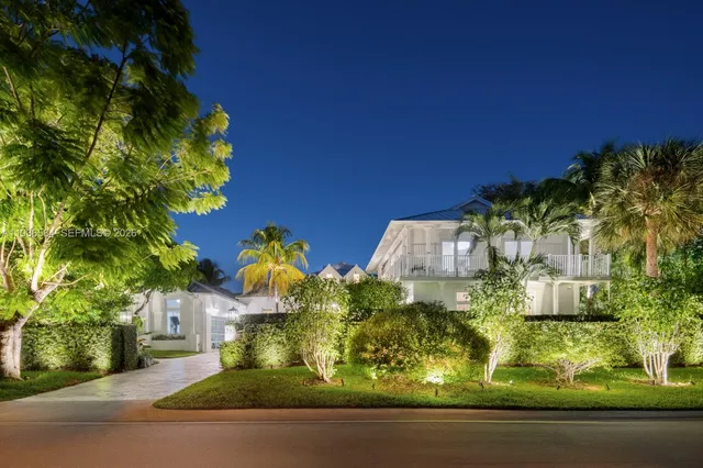 an aerial view of a house with a yard and swimming pool