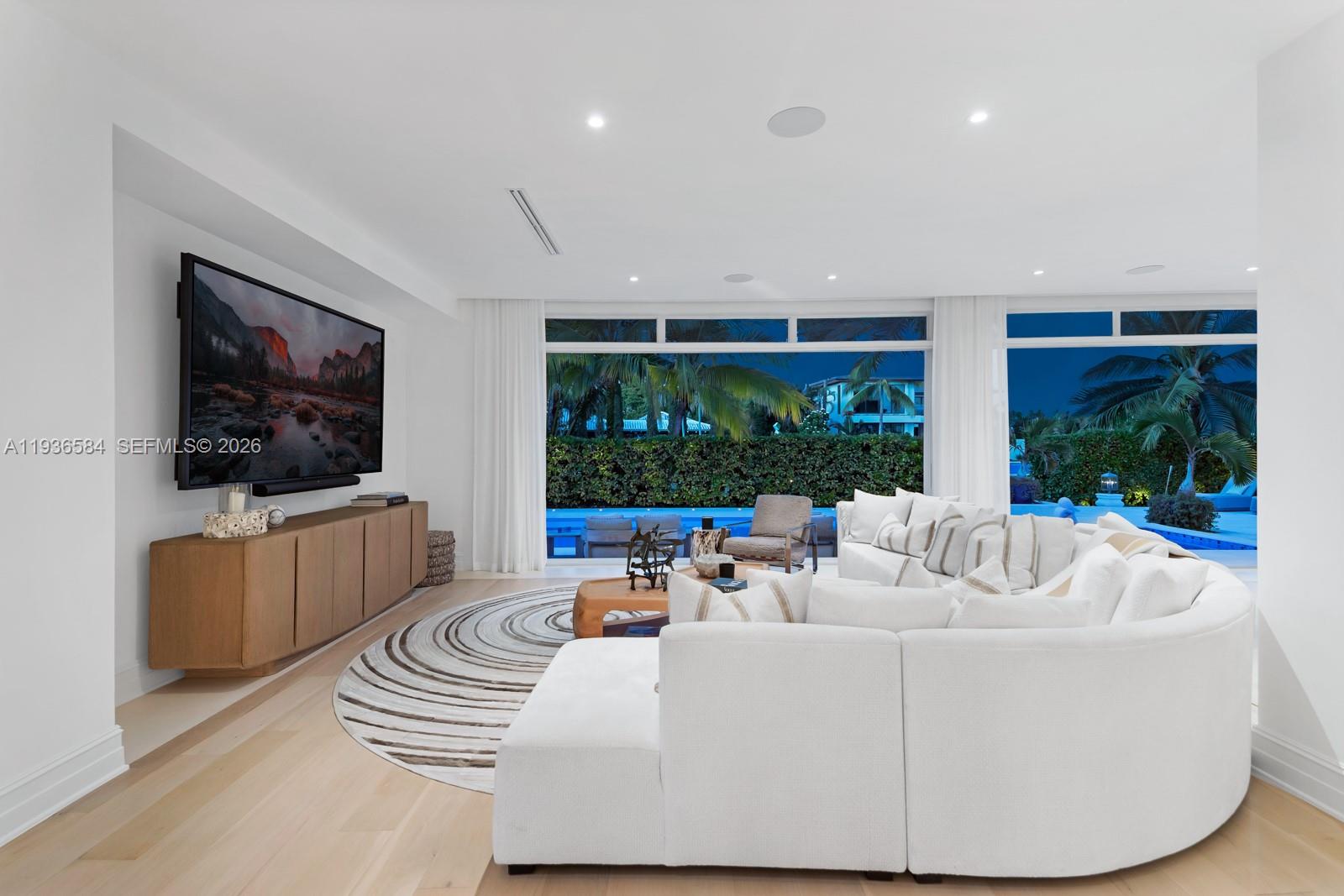 761 Buttonwood Lane Miami, FL 33137 - Photo 50 of 55 a living room with furniture a flat screen tv and floor to ceiling window