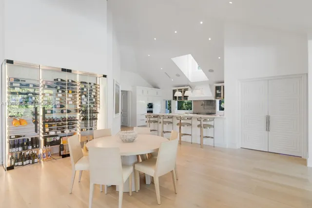 a dining room with furniture and view of kitchen