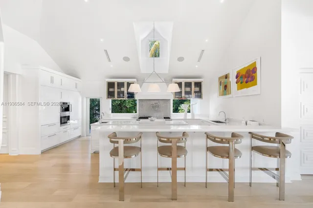 a view of a kitchen with a dining table chairs and microwave