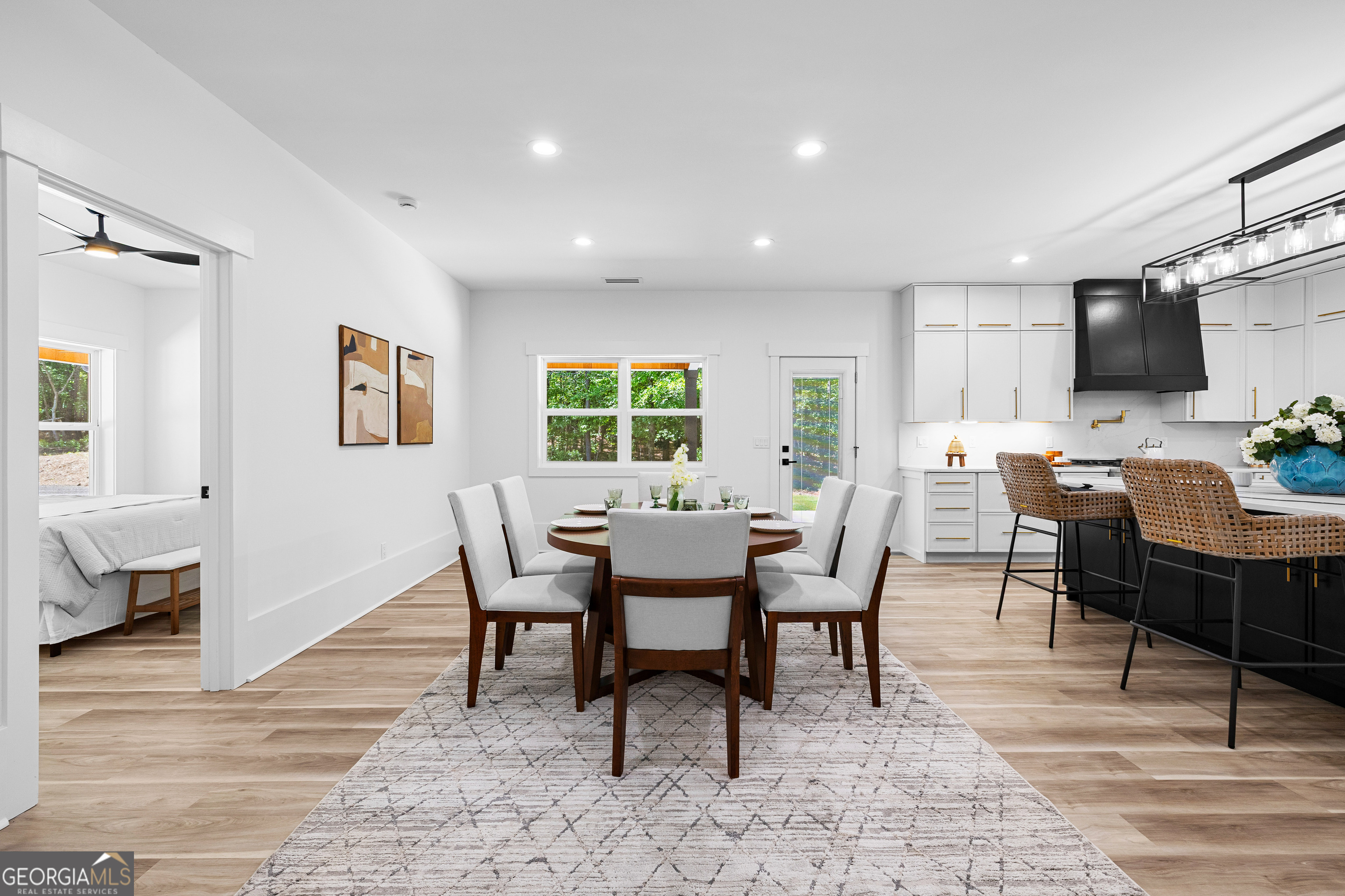 354 Turner Road Newnan, GA 30263 - Photo 30 of 79 a dining room with wooden floor a glass table and chairs