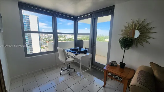 a living room with furniture and a floor to ceiling window