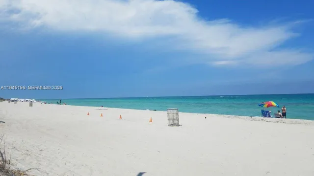 a view of a big house with a big yard and a large tree