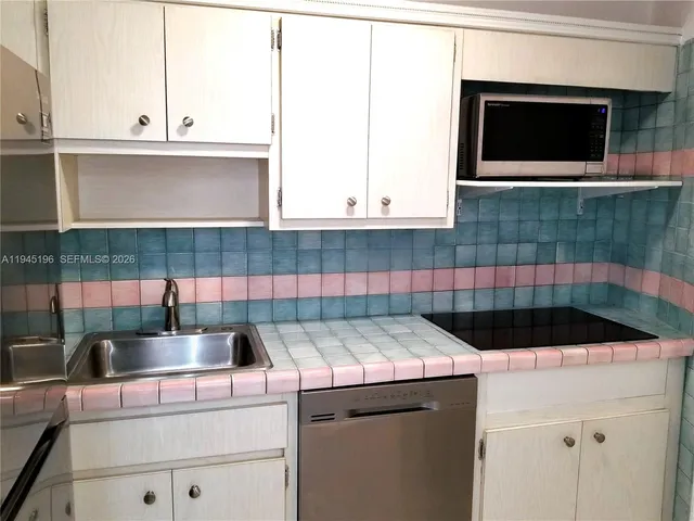 a kitchen with a sink and cabinets