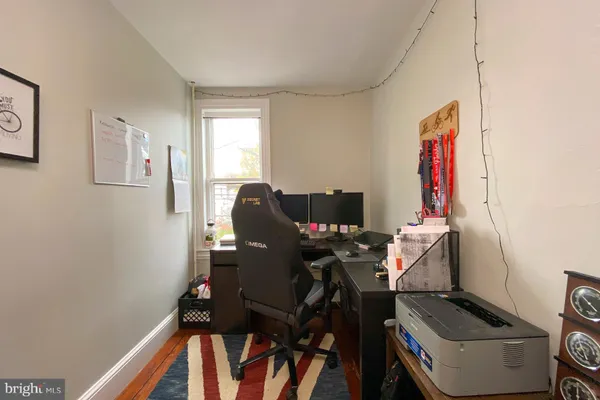 a view of a workspace with furniture and a window