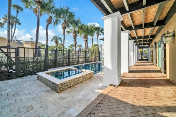a kitchen with stainless steel appliances kitchen island granite countertop a sink a stove a dining table and chairs