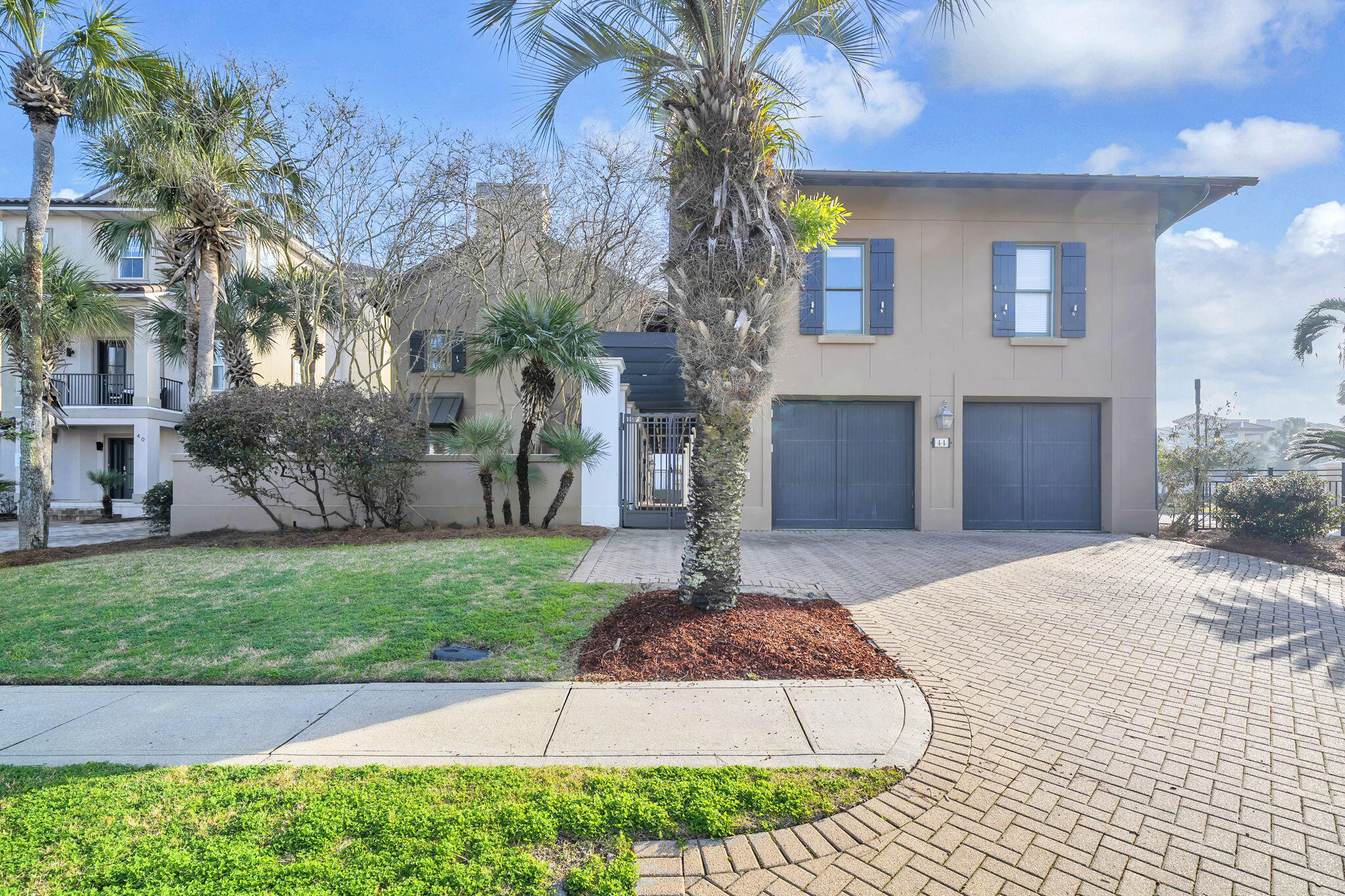 44 Tranquility Lane Destin, FL 32541 - Photo 2 of 82 a front view of a house with a yard and garage