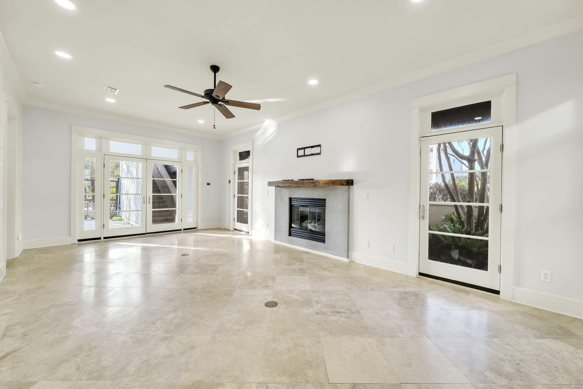 44 Tranquility Lane Destin, FL 32541 - Photo 21 of 82 a view of an empty room with a fireplace and chandelier fan