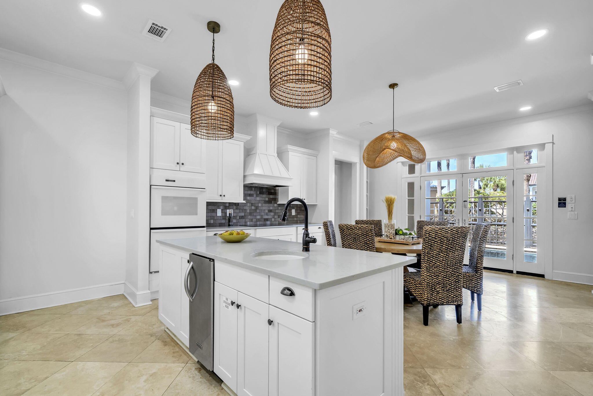 44 Tranquility Lane Destin, FL 32541 - Photo 22 of 79 a kitchen with stainless steel appliances granite countertop a stove a kitchen island a dining table and chairs