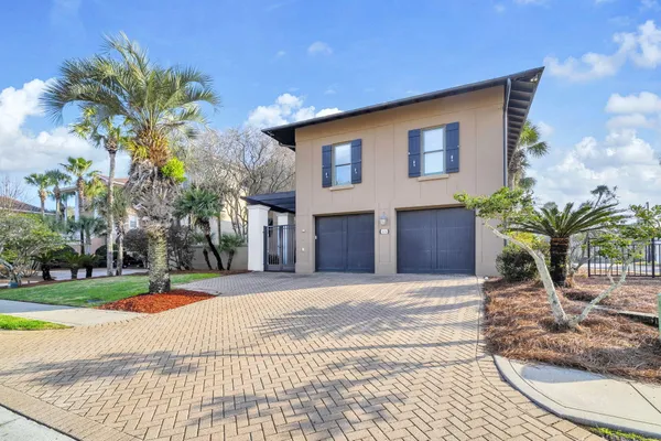 a front view of a multi story residential apartment building with a yard