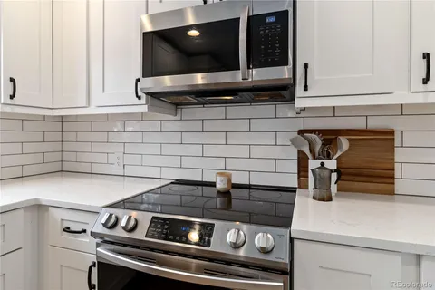 a kitchen with a stove and cabinets