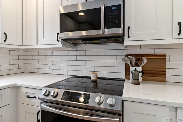 a kitchen with a stove and cabinets