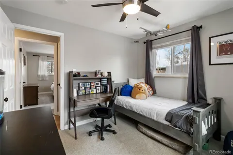 a bedroom with a bed and a couch