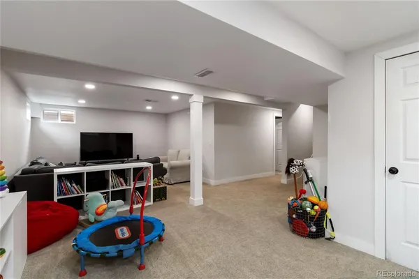 a bedroom with furniture and a lamp