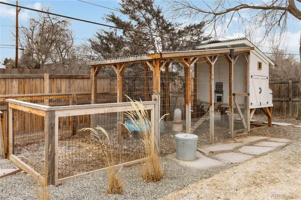 a backyard of a house with fire pit and couches