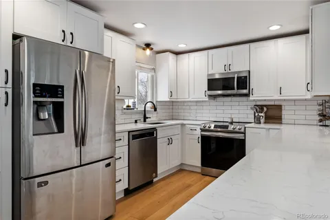 a kitchen with stainless steel appliances a refrigerator stove microwave and sink