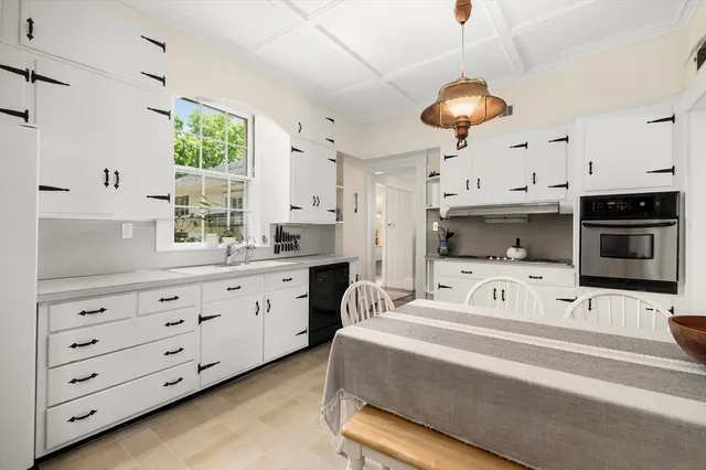 a spacious bedroom with a bed and a chandelier