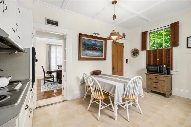 a dining room with furniture and window