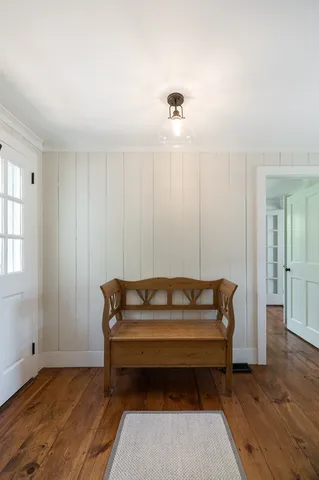 a living room with a couch and wooden floor