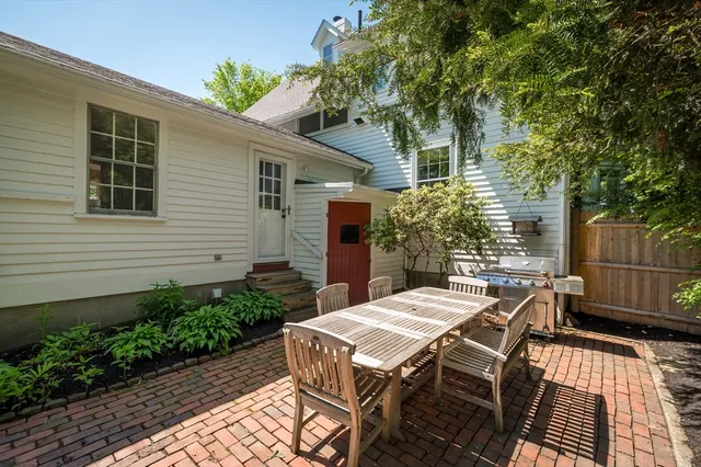 a view of a patio with table and chairs and potted plants