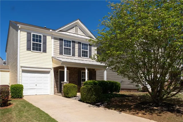 a front view of a house with a yard