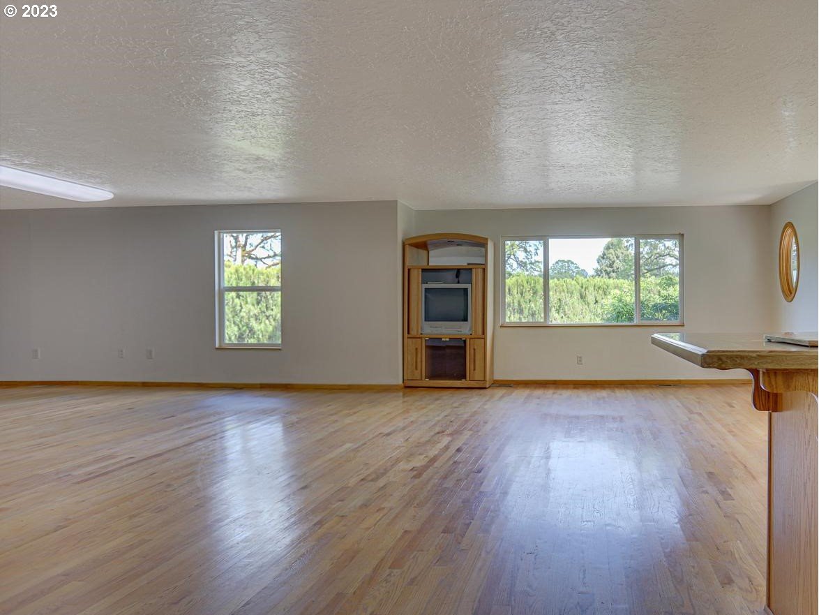 24347 Southeast Filbert Road Eagle Creek, OR 97022 - Photo 8 of 48 an empty room with wooden floor and windows