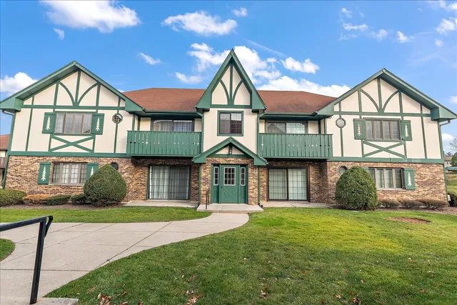 a front view of a house with a yard and outdoor seating