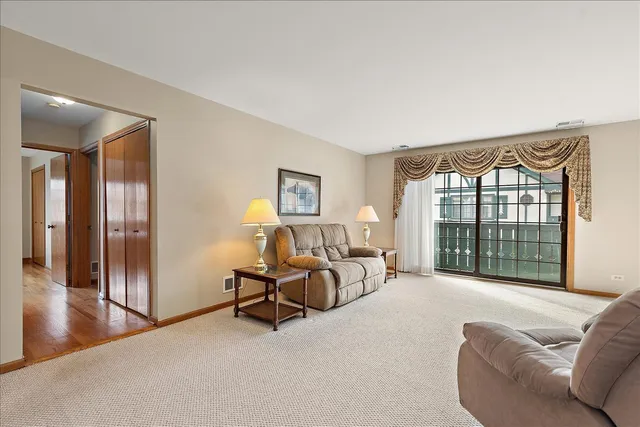 a bedroom with furniture and a large window