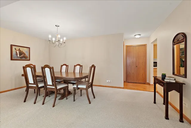 a view of a dining room with furniture and chandelier