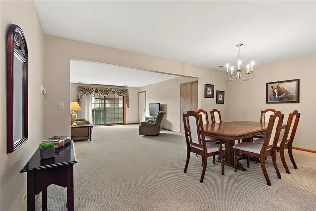 a view of a dining room with furniture and chandelier