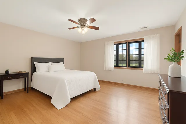 a bed room with a bed and a potted plant