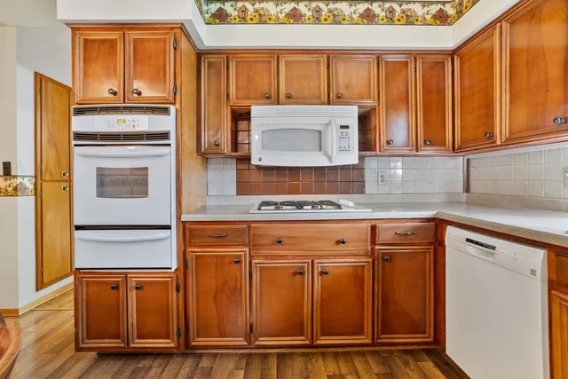 a kitchen with stainless steel appliances granite countertop a refrigerator and cabinets