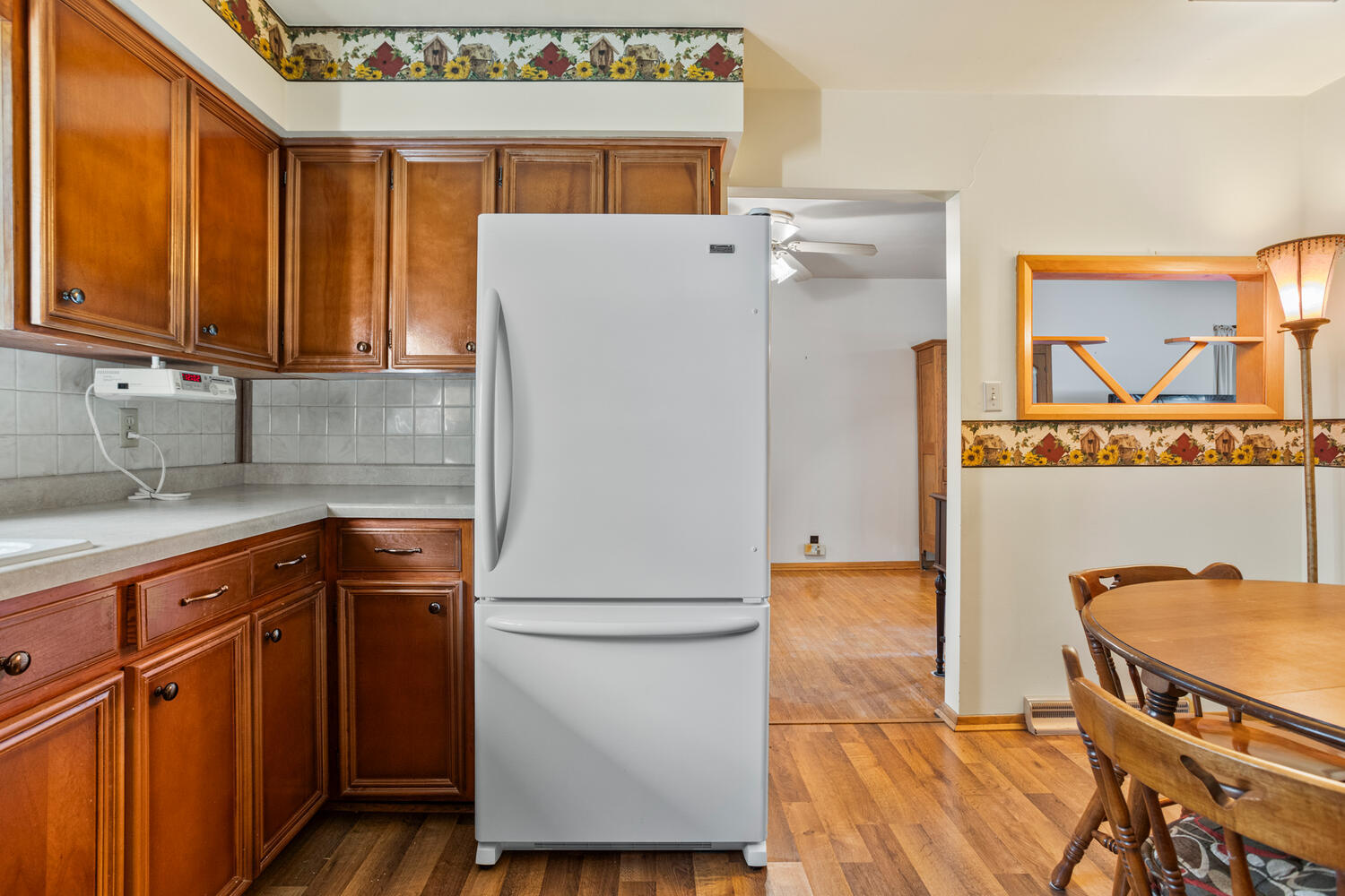 509 East Oak Street Chatsworth, IL 60921 - Photo 13 of 33 a kitchen with a refrigerator a sink and wooden cabinets