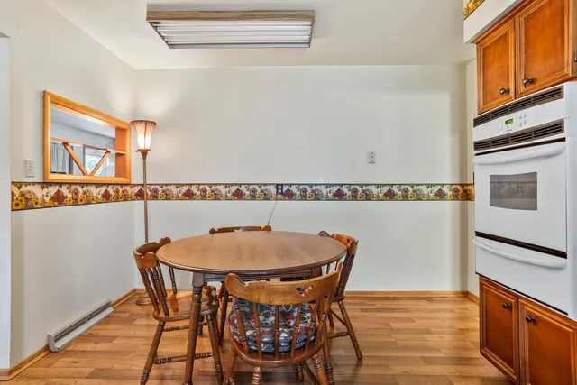 a view of a dining room with furniture and wooden floor