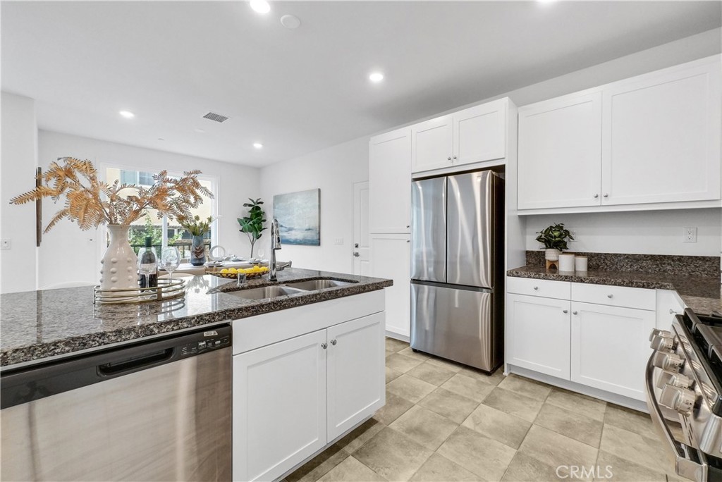 5584 Kate Way, Unit 10 Fontana, CA 92336 - Photo 7 of 42 a kitchen with refrigerator and cabinets