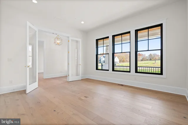 an empty room with windows and closet