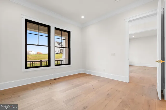 a kitchen with white cabinets and sink