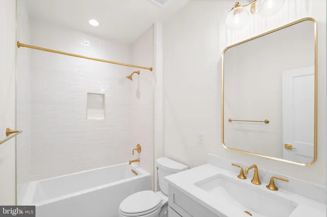 a bathroom with double vanity sinks and a bathtub