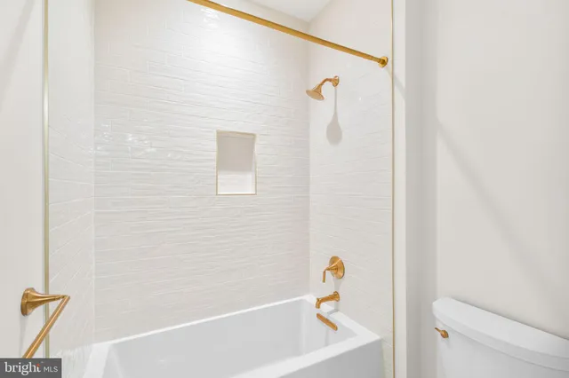 a bathroom with a shower sink and mirror