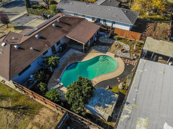 an aerial view of a residential houses with outdoor space