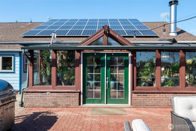 a view of a house with large trees and a small yard