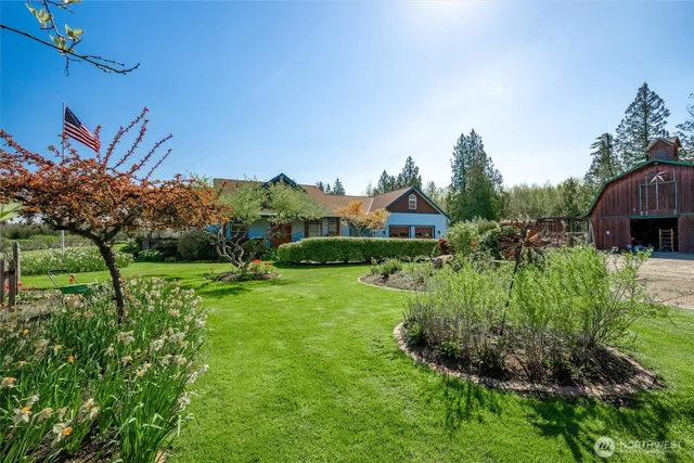 a view of backyard with garden and outdoor seating
