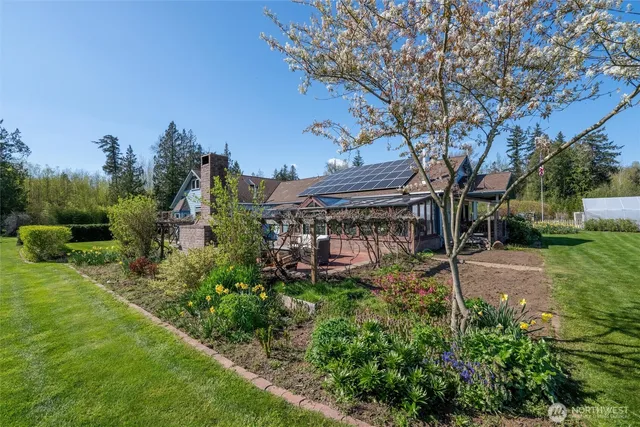 a view of a porch with furniture and a yard