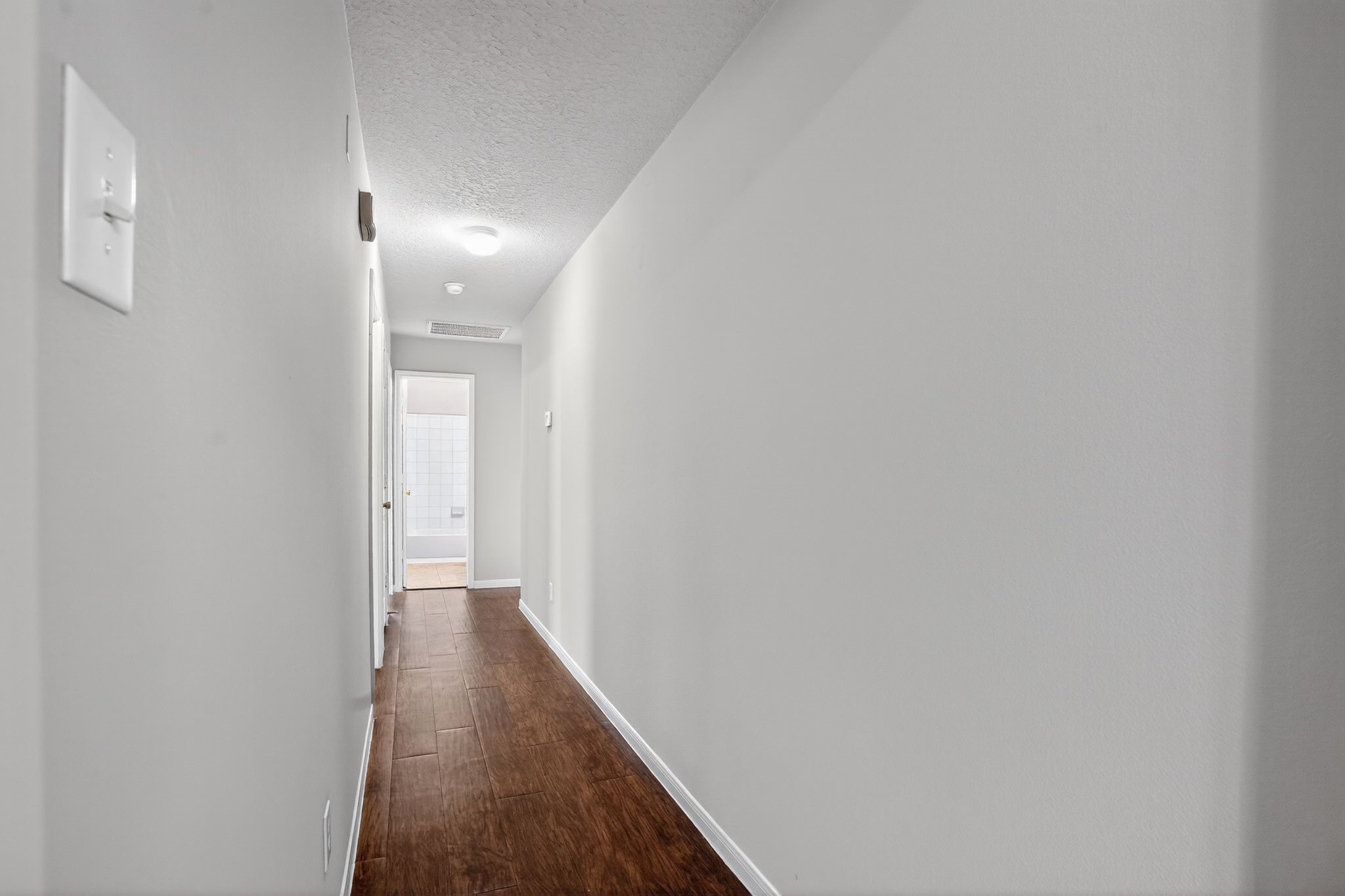 29414 Winton Wood Way Spring, TX 77386 - Photo 19 of 35 a view of a hallway with wooden floor