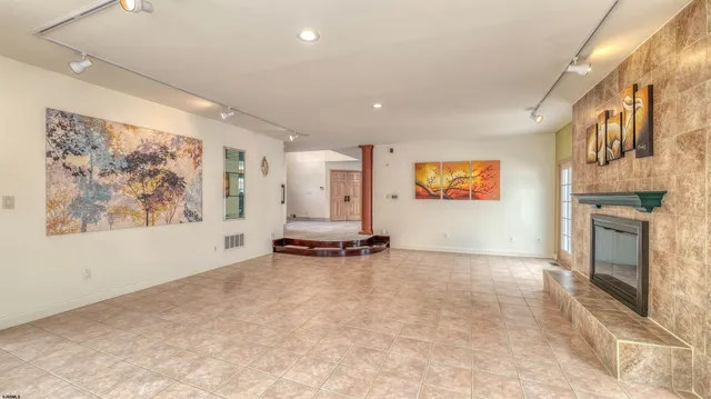 a bathroom with a granite countertop sink toilet a mirror and shower