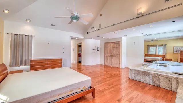 a view of a big yard with an ocean view