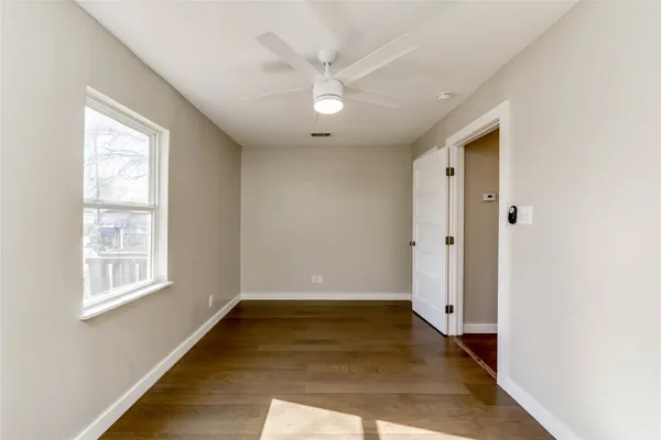 wooden floor in an empty room with a window