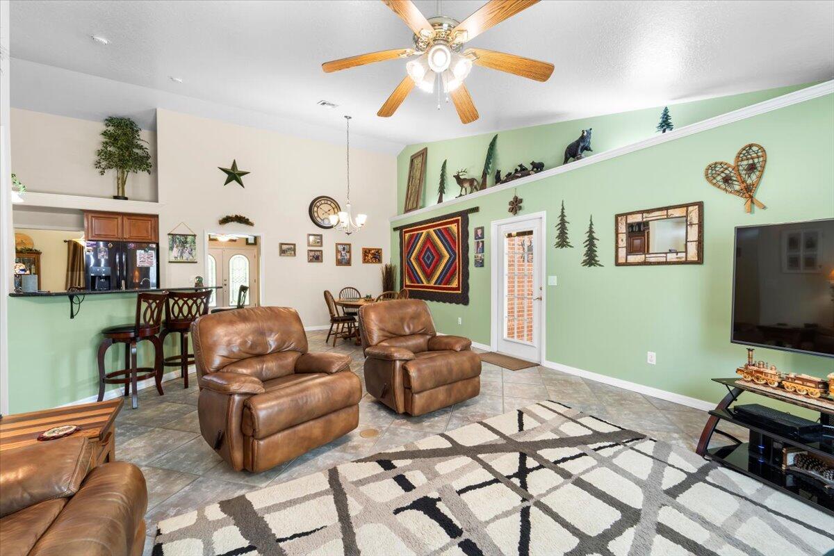 3455 Carter Road Mims, FL 32754 - Photo 24 of 38 a living room with furniture and a flat screen tv